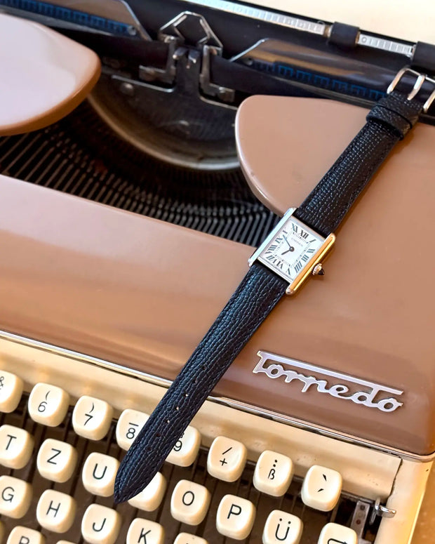 French-Style Cowhide 9 to 5 on the Cartier Tank Must SolarBeat Small on a typewriter