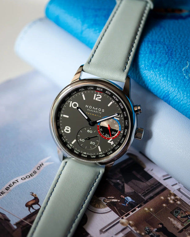 Classic Calfskin Fresh on NOMOS Club Sport neomatik Worldtimer Volcano – lifestyle shot, front view